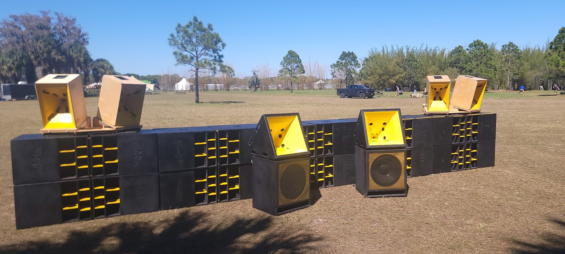 T Lounge four-point tower array laid out at Okeechobee Music Festival — four SKRAM sub towers with JMOD horns on top, spaced across the stage plot